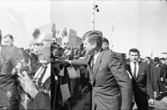 Image of President Kennedy greeting the crowd at Love Field