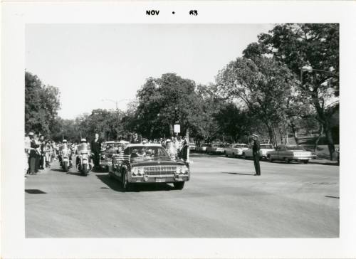 Photograph of the presidential limousine driving down Turtle Creek Boulevard