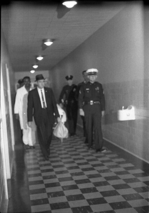 Image of officials escorting the body of Lee Harvey Oswald to the morgue