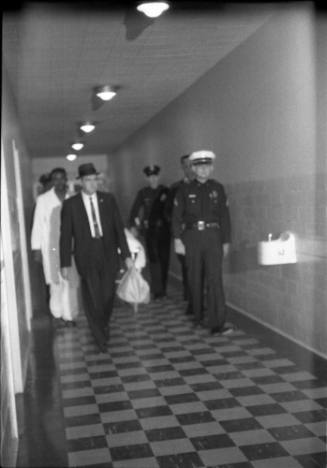 Image of officials escorting the body of Lee Harvey Oswald to the morgue