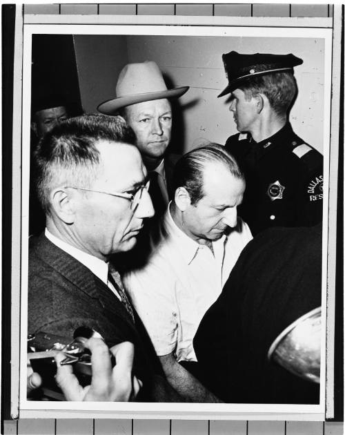 Image of Jack Ruby being escorted through the courthouse hallway