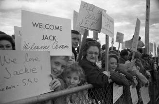 Image of crowd with signs at Love Field