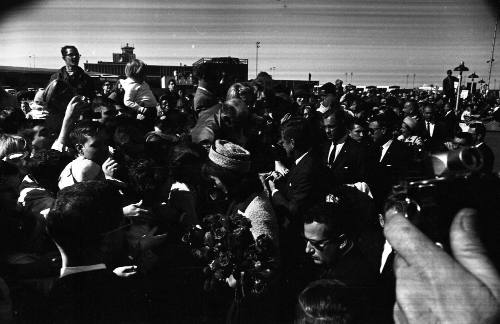 Image of President and Jackie Kennedy greeting the crowd at Love Field