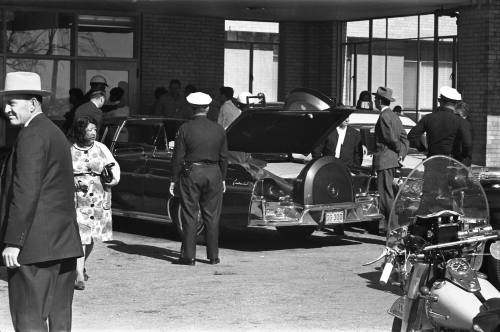 Image of the cover being put on the presidential limousine at Parkland Hospital