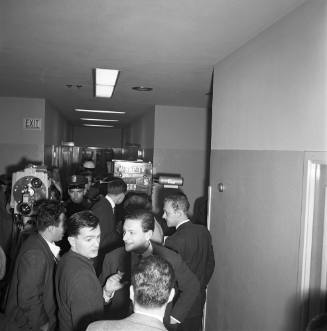 Image of reporters in hallway of Dallas Police Department Headquarters