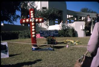 Image of floral cross and other tributes in Dealey Plaza