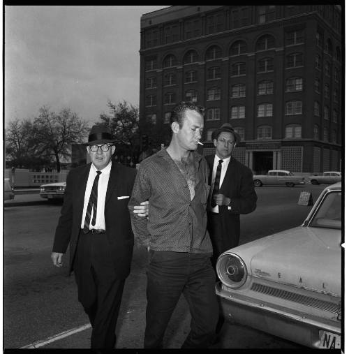 Image of jailbreaker Frank Crocker in Dealey Plaza, escorted by police