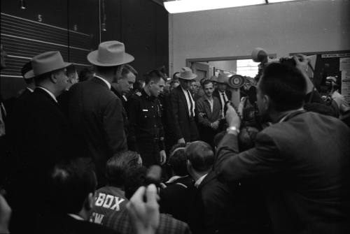 Image of Lee Harvey Oswald being led into the midnight press showing