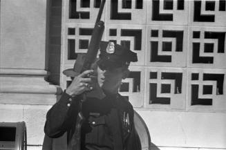 Image of a Dallas Police officer outside of the Texas School Book Depository