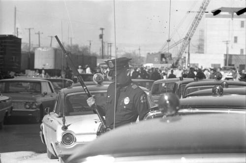 Image of a Dallas Police officer guarding the Texas School Book Depository