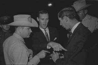 Image of law enforcement checking press credentials at Carswell Air Force Base