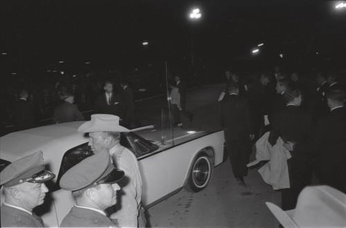 Image of official party boarding vehicles at Carswell AFB in Fort Worth