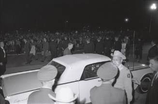Image of official party boarding vehicles at Carswell AFB in Fort Worth