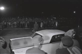 Image of official party boarding vehicles at Carswell AFB in Fort Worth