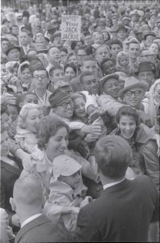 Image of President Kennedy greeting the crowd in front of the Hotel Texas