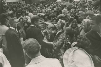 Image of President Kennedy greeting the crowd in front of the Hotel Texas