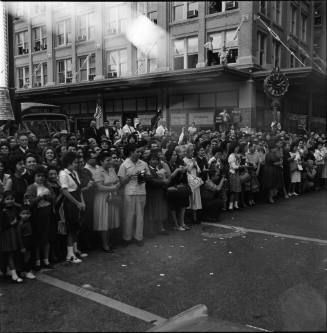 Image of crowd gathered for motorcade along street in downtown San Antonio