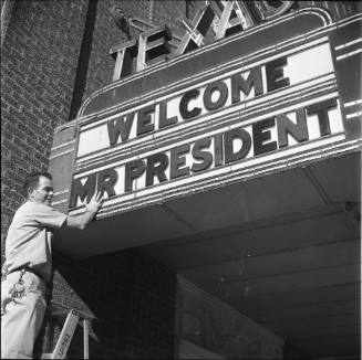 Image of a man preparing the Hotel Texas "Welcome Mr. President" marquee