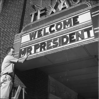 Image of a man preparing the Hotel Texas "Welcome Mr. President" marquee