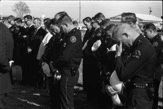 Policemen bowing their heads at Officer J.D. Tippit's funeral