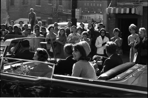 Photograph of presidential limousine at Harwood and Live Oak Streets in Dallas