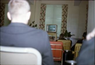 35mm color slide of people watching President Kennedy's funeral on television