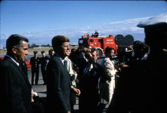 Image of President Kennedy being photographed by the press at Love Field