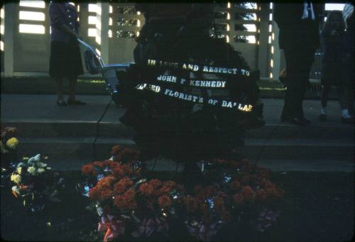 Image of memorial flowers in Dealey Plaza after the assassination