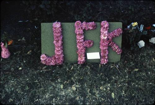 Image of memorial flowers in Dealey Plaza after the assassination