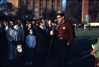 Image of news reporter interviewing an unknown man in Dealey Plaza