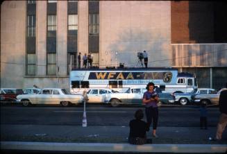 Image of a WFAA-TV news van parked along Houston Street