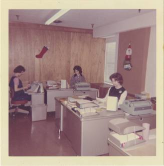 Color photograph of three women at work in the Texas School Book Depository