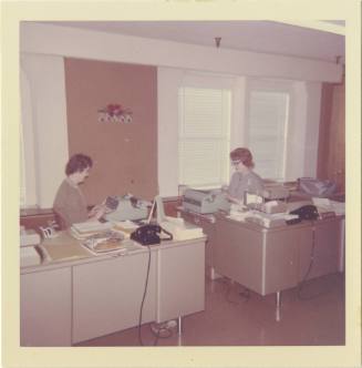 Color photograph of two women at work in the Texas School Book Depository