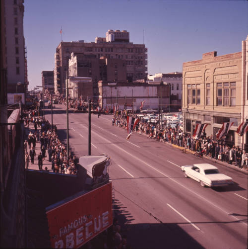 Color image of crowds lining Main Street waiting for the Presidential motorcade