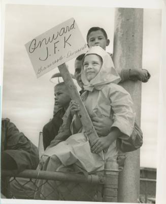 Image of a child holding a sign at Dallas Love Field