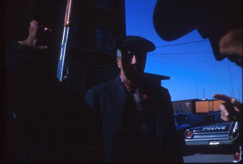 Image of a police officer speaking with a witness in Dealey Plaza