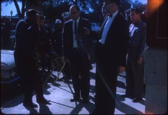 Image of Lt. J. C. "Carl" Day holding rifle outside the Book Depository