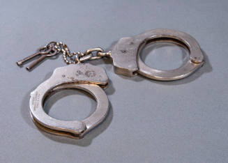 Peerless steel handcuffs, keys and leather holster used by Elmer Boyd