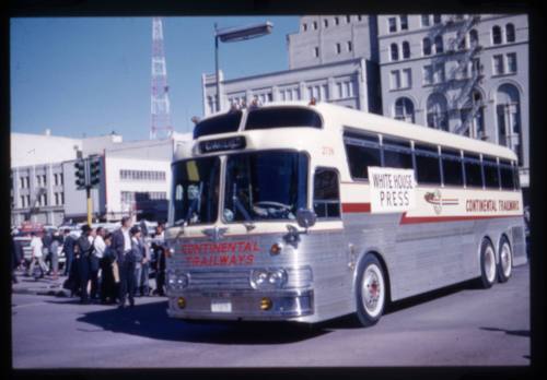 Image of a White House Press bus in the Kennedy motorcade on Main Street