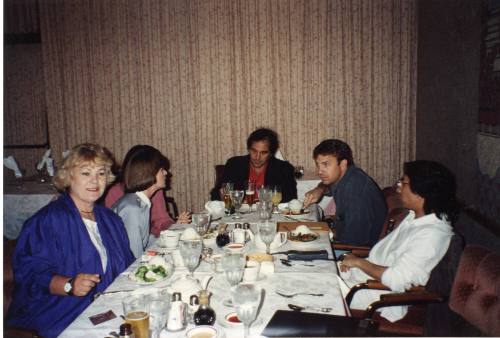 Photograph of Oliver Stone, Kevin Costner and Marina Oswald at dinner