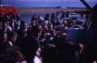 Image of President Kennedy greeting the crowd at Love Field