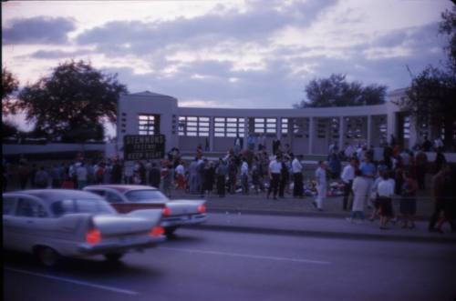 Image of flowers and crowds gathered in Dealey Plaza