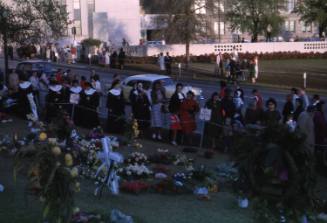 Image of mourners and flowers in Dealey Plaza after the assassination, Slide #32